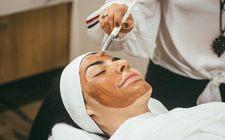 A woman applying a face pack