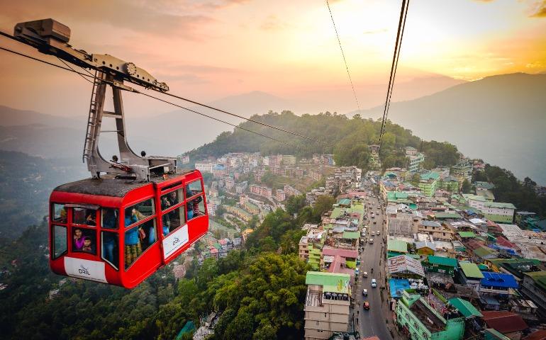 Tourists enjoying a ropeway cable car/Gondola ride over Gangtok city
