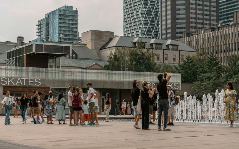 Crowd Standing at the Fountain
