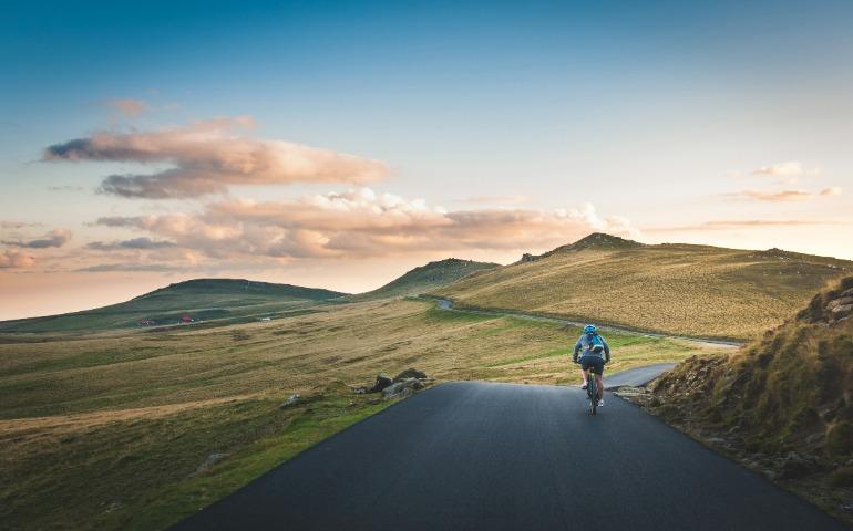 A person cycling in a scenic landscape

