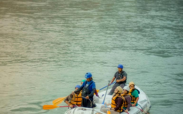 Group of People Enjoying River Rafting in Rishikesh
