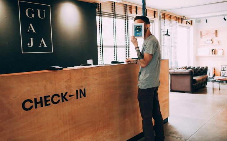 Man standing beside check - in counter