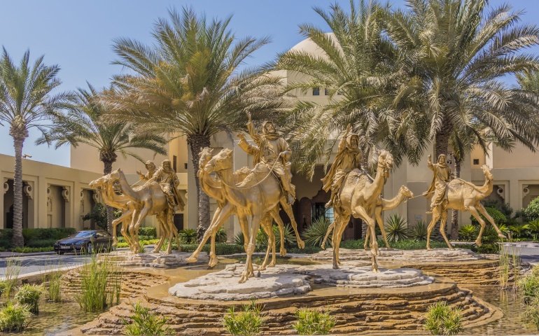 Huge gold camels decorated entrance in 5 star hotel One&Only Royal Mirage
