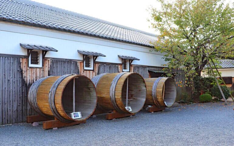 Three big wooden tanks in a Japanese sake brewery