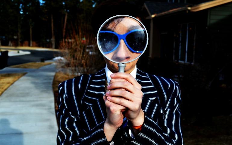 A person holding a magnifying glass
Image Credit: Marten Newhall/Unsplash