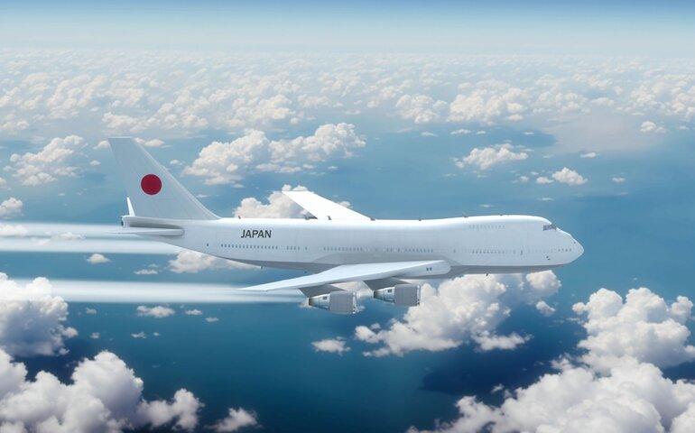 Commercial Airliner Passanger Plane Jumbo Jet Flying over Clouds with Country Flag Japan