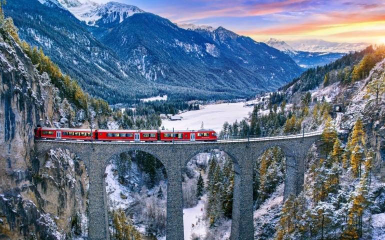 Aerial view of Train passing through famous mountain in Filisur, Switzerland - The Swiss Alps