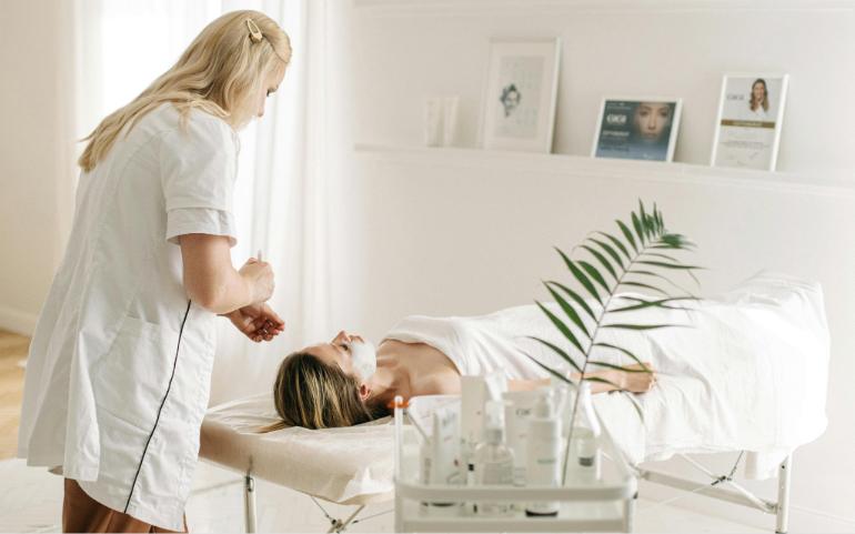 A Dermatologist Applying Facial Mask on Customer's Face