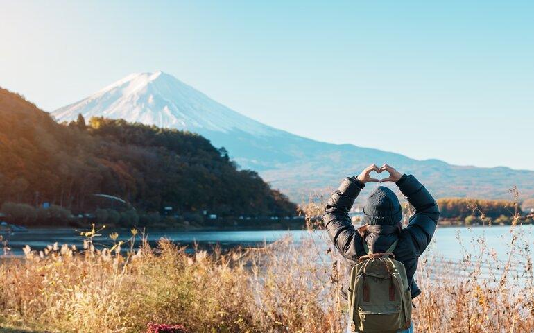 A tourist posing near Mt. Fuji in Japan