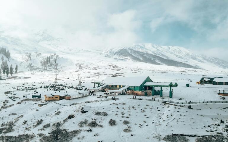 Wooden House in a Valley Covered in Snow
