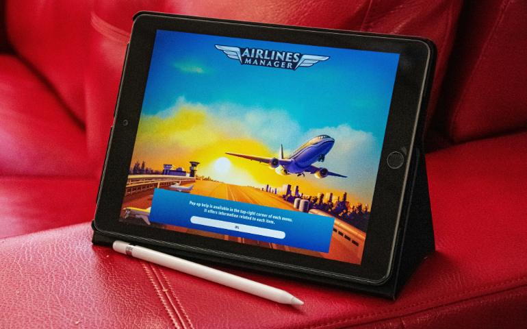 A Tablet Sitting on Top of a Red Couch