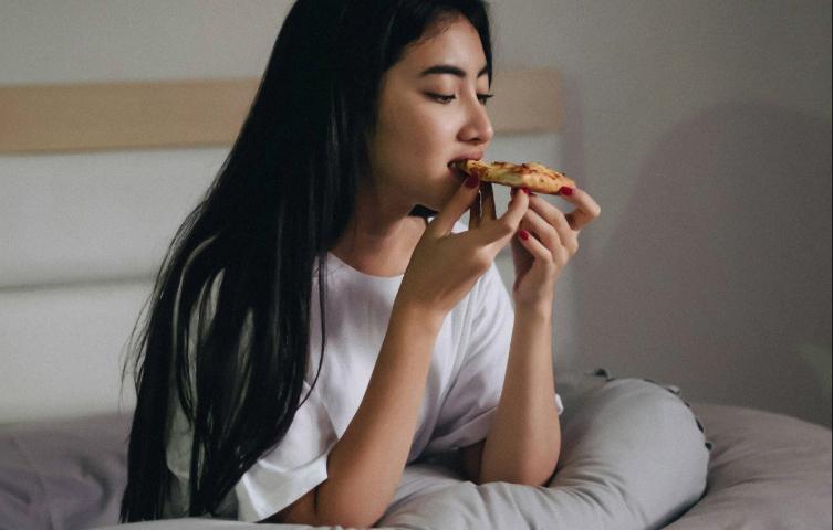 Women Enjoying Pizza in her room 
