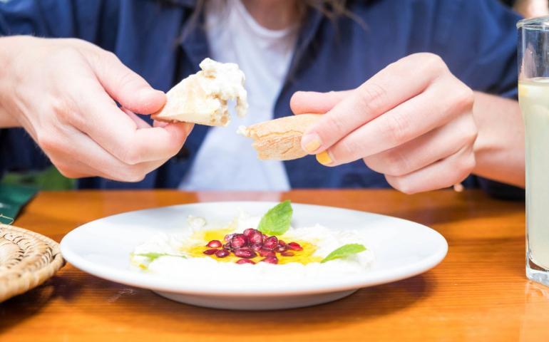 Woman eating a Mediterranean dish
