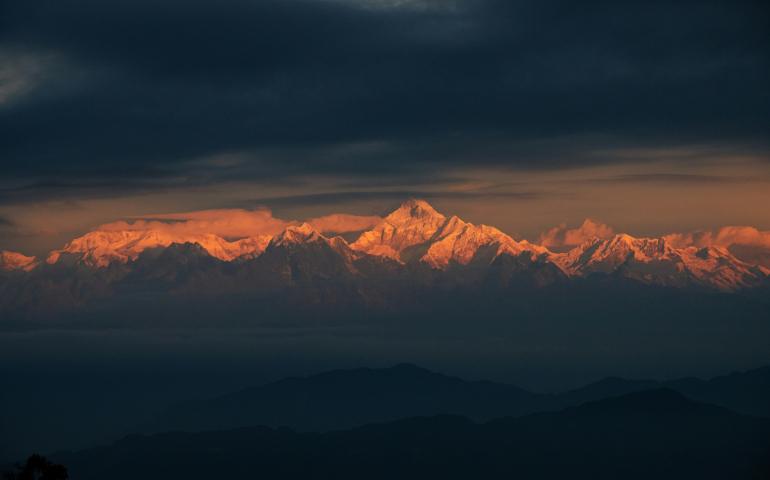 In the embrace of dawn's first light, Kanchenjunga's pristine slopes emerge