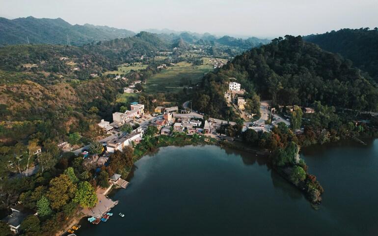 An aerial view of a village and a lake
