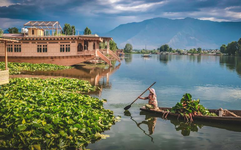 An Indian woman rowing the boat known as "Shikara" in Srinagar, Kashmir.

