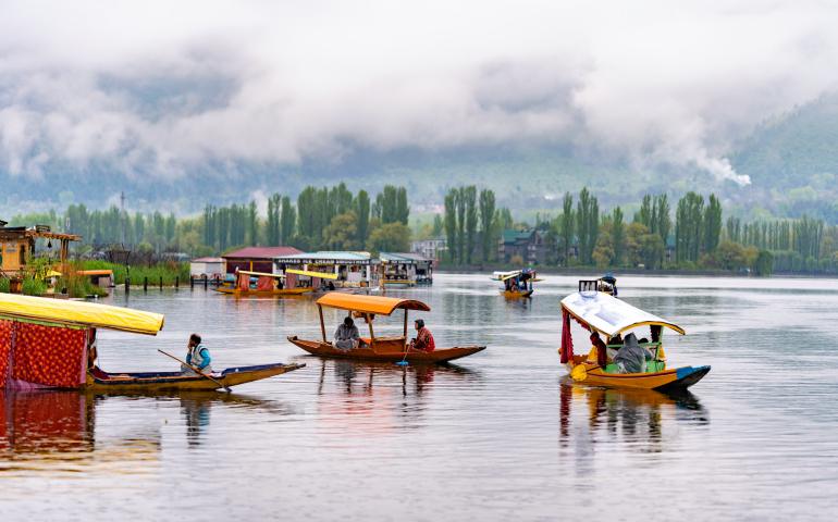 a group of boats floating on top of a lake
