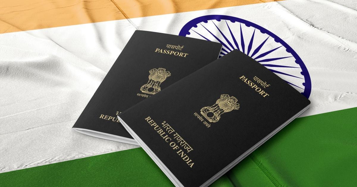 Indian Passport with the Indian flag in the background
