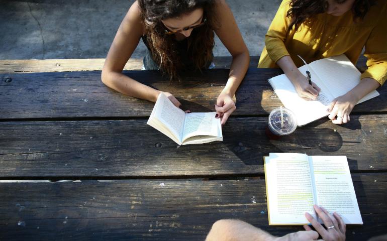 People journaling and reading books
