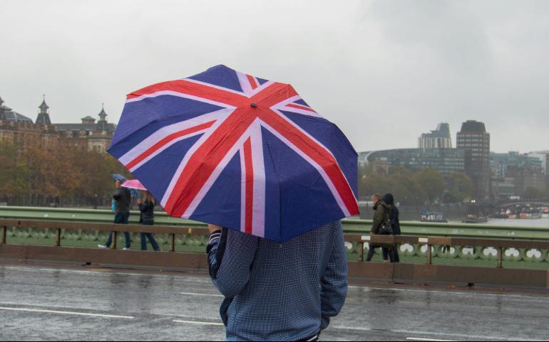 A man with an umbrella in the colors of the British flag

