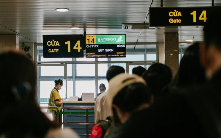 People Queuing at an Airport Gate