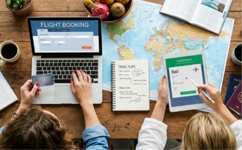 Women planning trip and searching for flights online