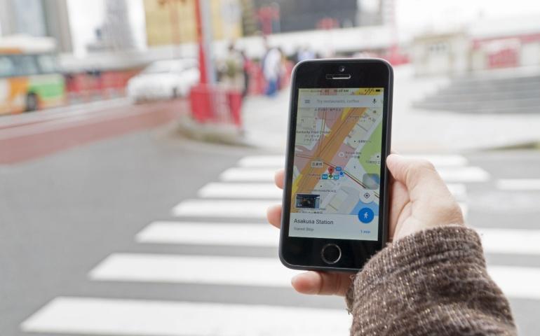 A traveller using Google Maps as a travel guide to navigate through Tokyo in Japan