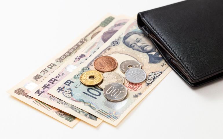 A wallet with Japanese cash in Yen - Japan travel guides recommend carrying cash