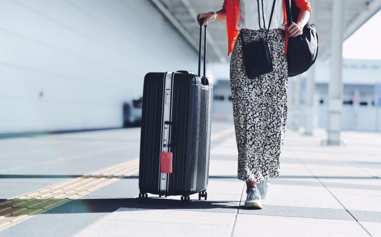 A traveller walking with her luggage in Japan