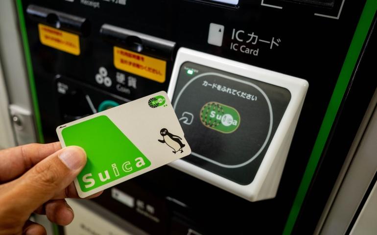 Traveller using a transport/electronic money card in Japan