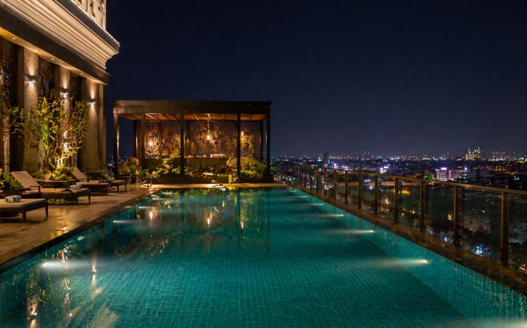 Hotel pool with city lights
