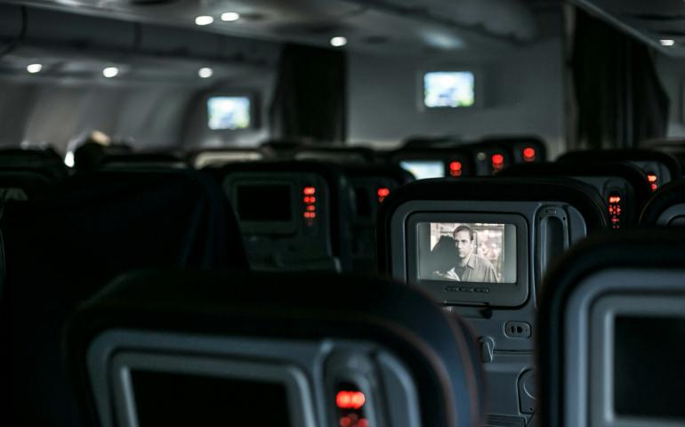 Seats in the Airplane with a Movie on a Screen