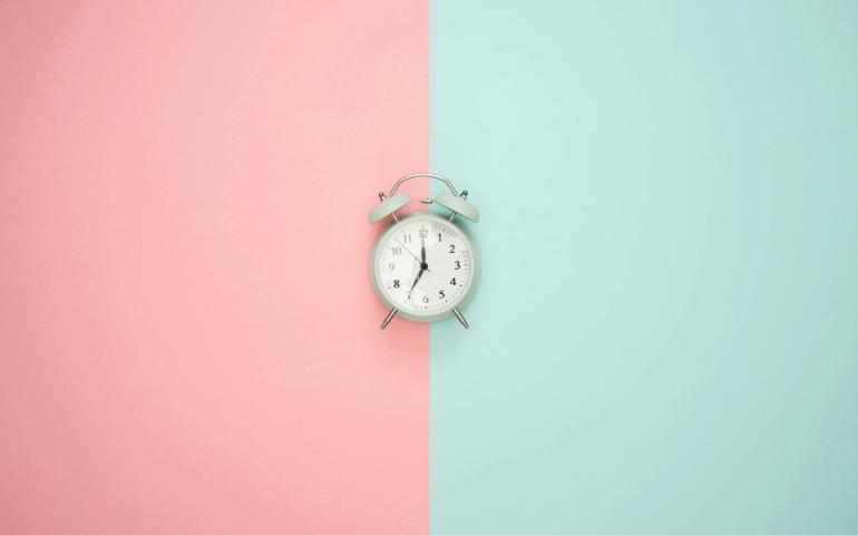 Blue Clock on a Pastel Background