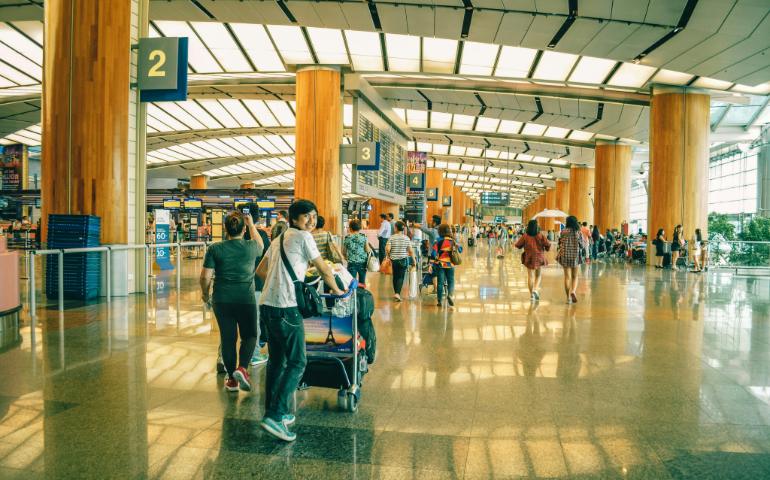 A young boy walking in airport 
