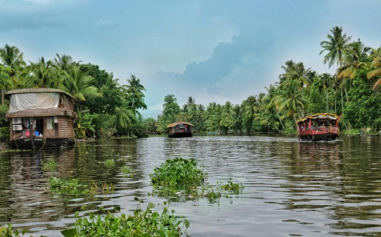 Tourists exploring the serene Kerala backwaters during the monsoon