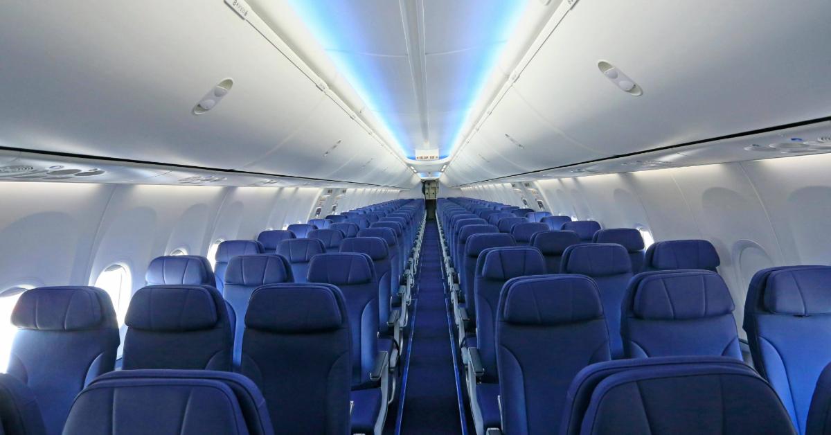 Empty airplane cabin with rows of blue seats 
Jeffry Surianto/Pexels