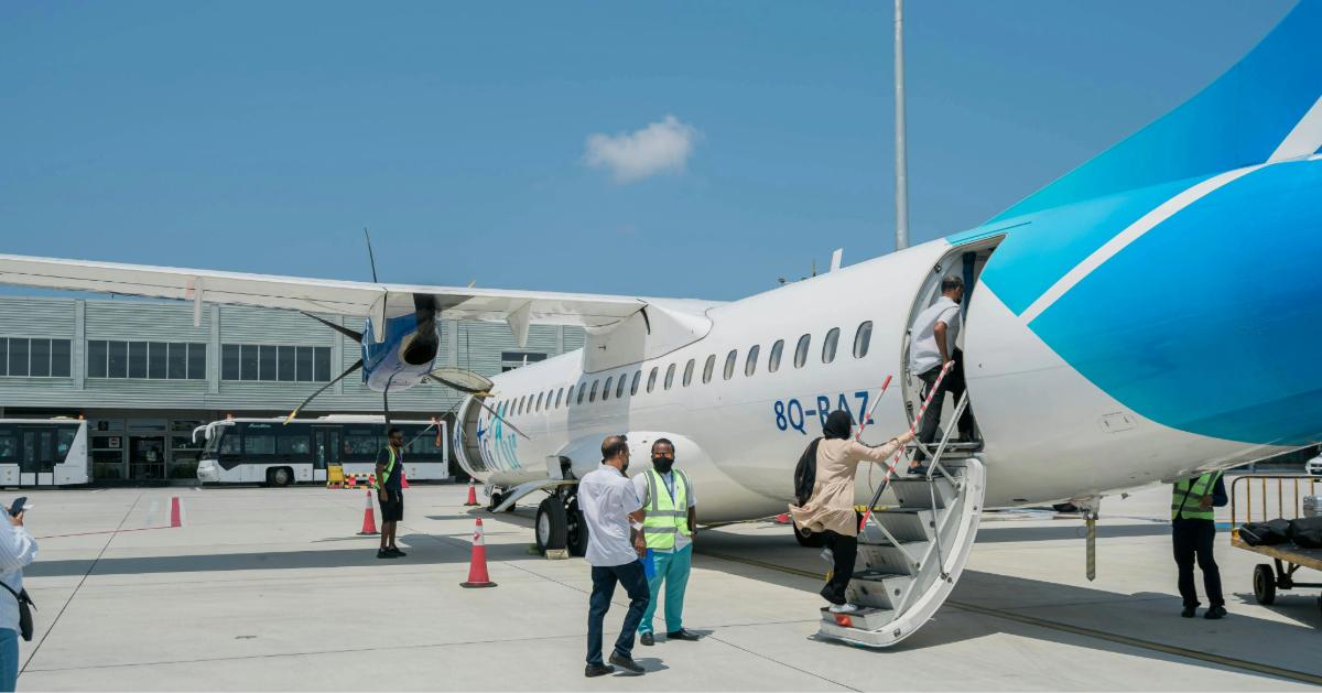 Passengers board a blue and white ATR 72 aircraft at an airport under clear skies Image Credit: Asad Photo Maldives/Pexels