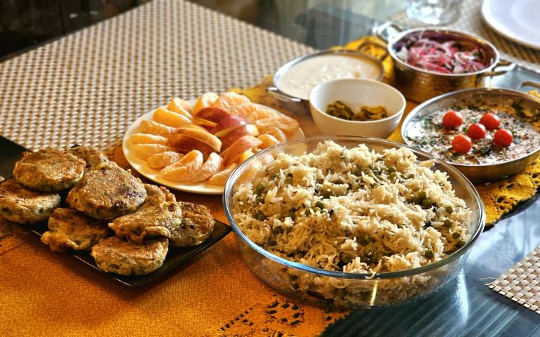 A Vibrant Indian Meal Featuring Rice and Various Dishes