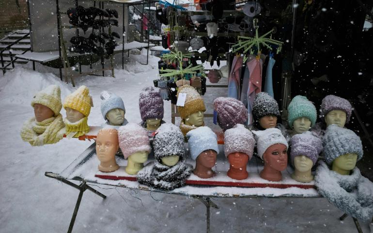 Snow-covered Knit Hats Displayed in a Winter Street Market Stall.
