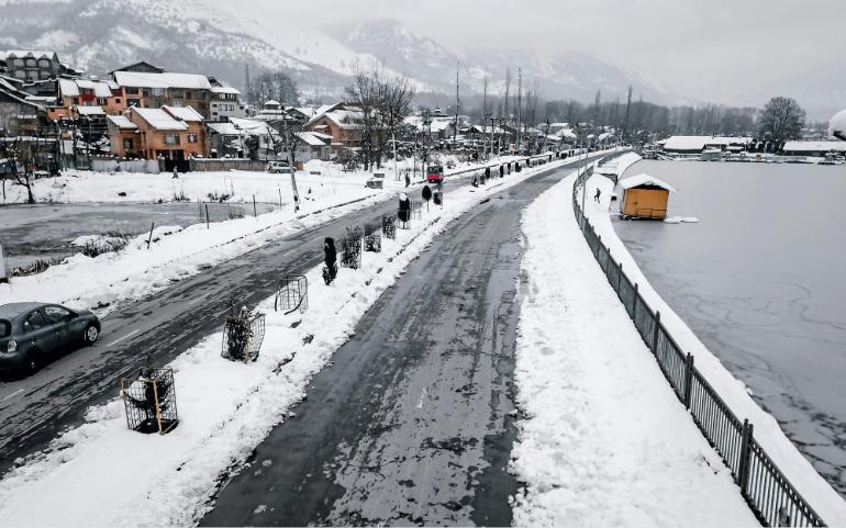 Winter View of Dal Lake and Surrounding Roads Blanketed in Snow in Srinagar.