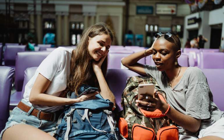 Two Young Women Checking their Smartphones