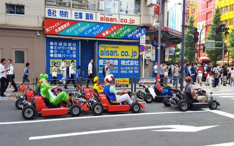 Anime enthusiasts riding Go-karts in the streets of Akihabara, Tokyo
