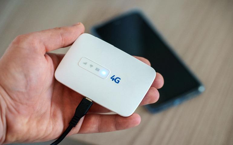 A traveller holding a modern wireless pocket 4g wifi modem