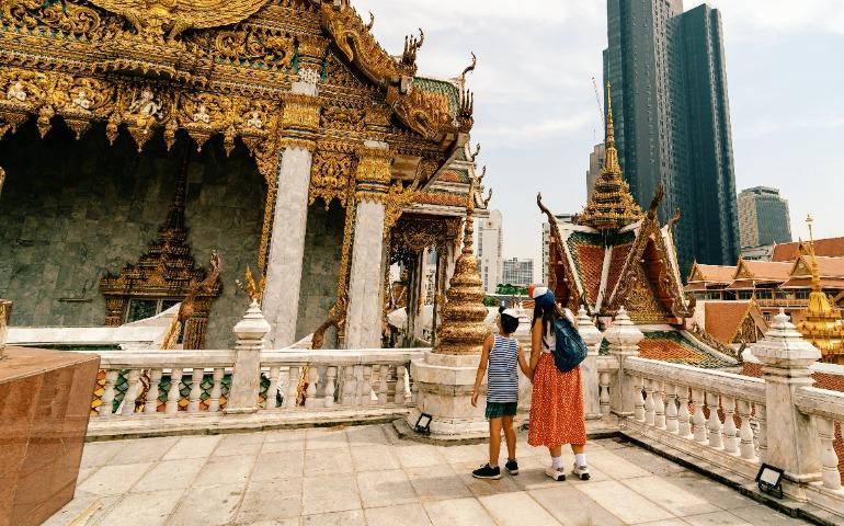 Family visiting ancient temple in Bangkok
