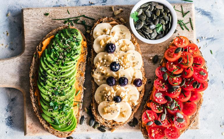 Bread toasts with avocado, banana and tomato