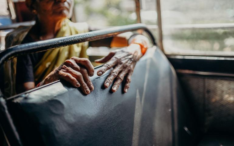 A Woman's Hands on a Bus Seat