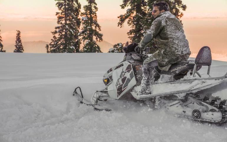 A Man Rides a Snowmobile Through Fresh Snow in Gulmarg