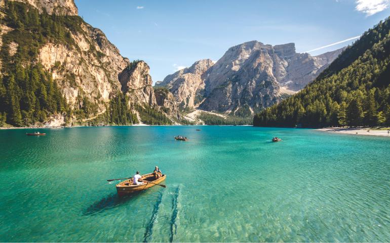 People boating on clear water
