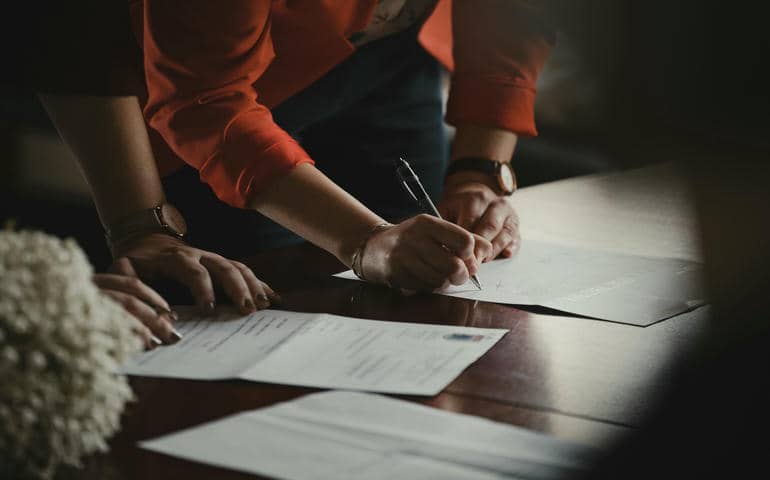 A man signing some documents