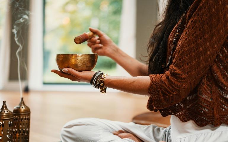 Woman doing rituals before meditation